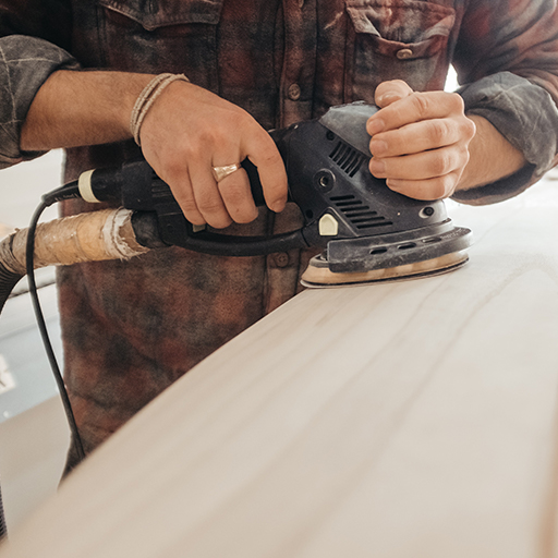 man sanding wood